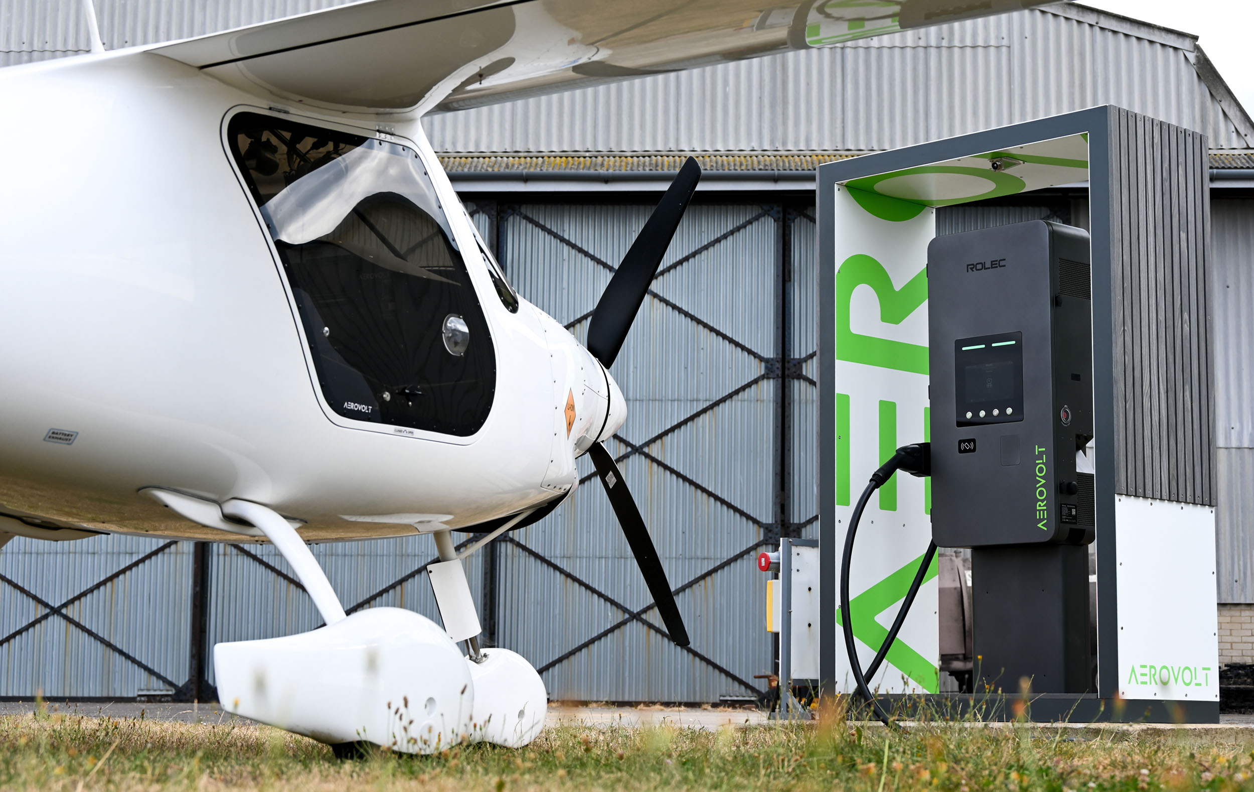 Electric aircraft beside an AeroVolt charging station at Brighton City Airport